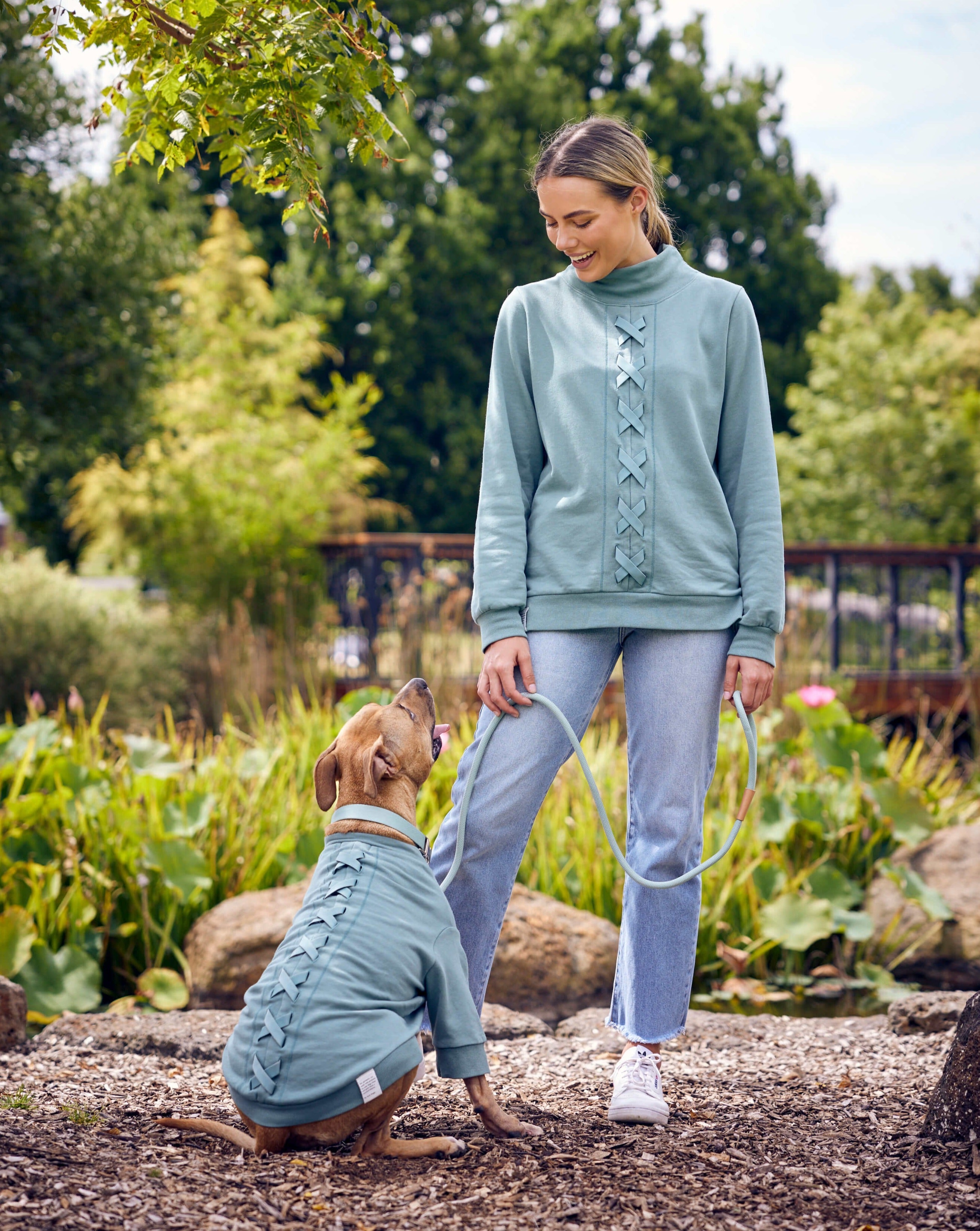 A girl and her dog in the park wearing Darren and Phillip match your dog sweats.