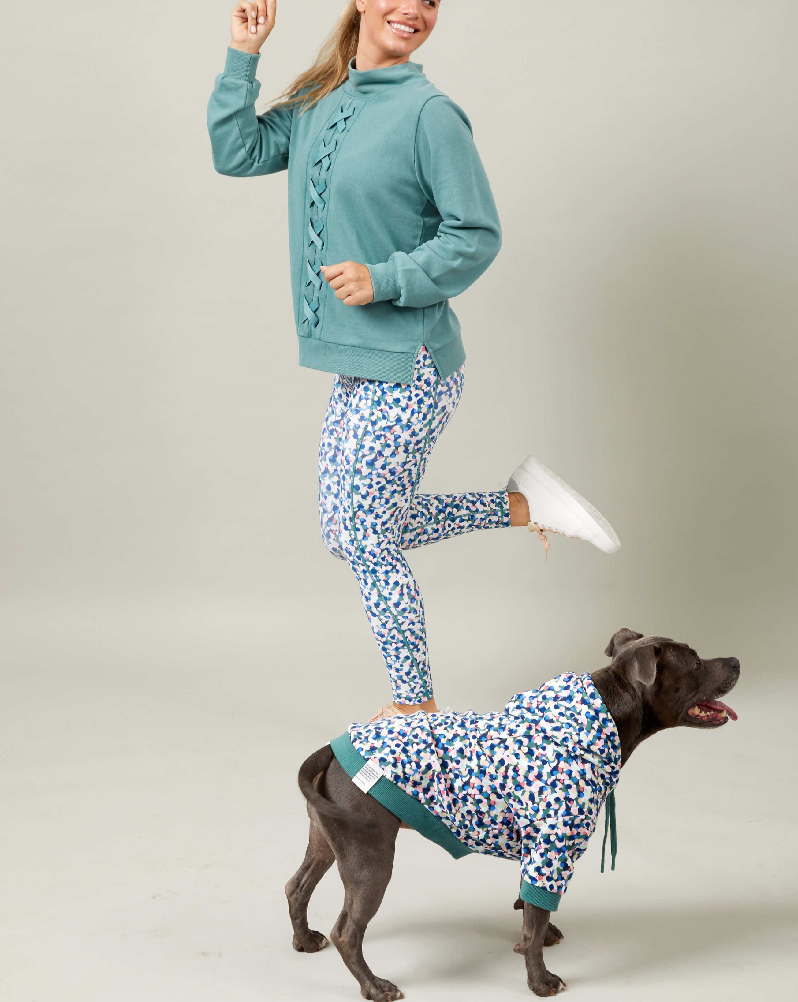 A girl and her dog in match your dog hoodie.