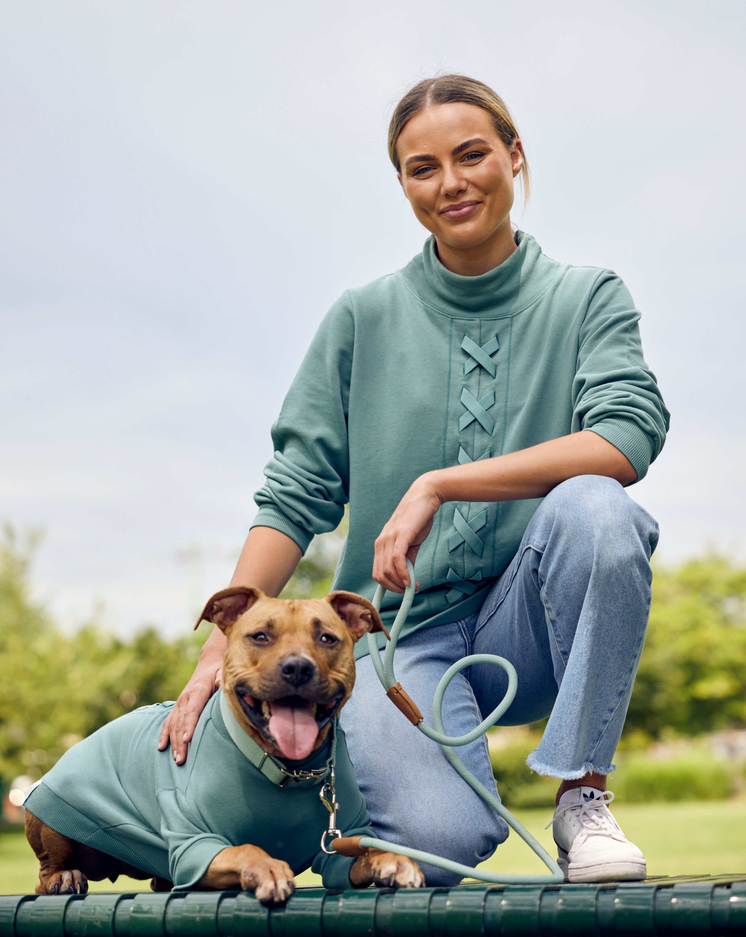 A girl and her staffy wearing match your dog sweats from Darren and Phillip.