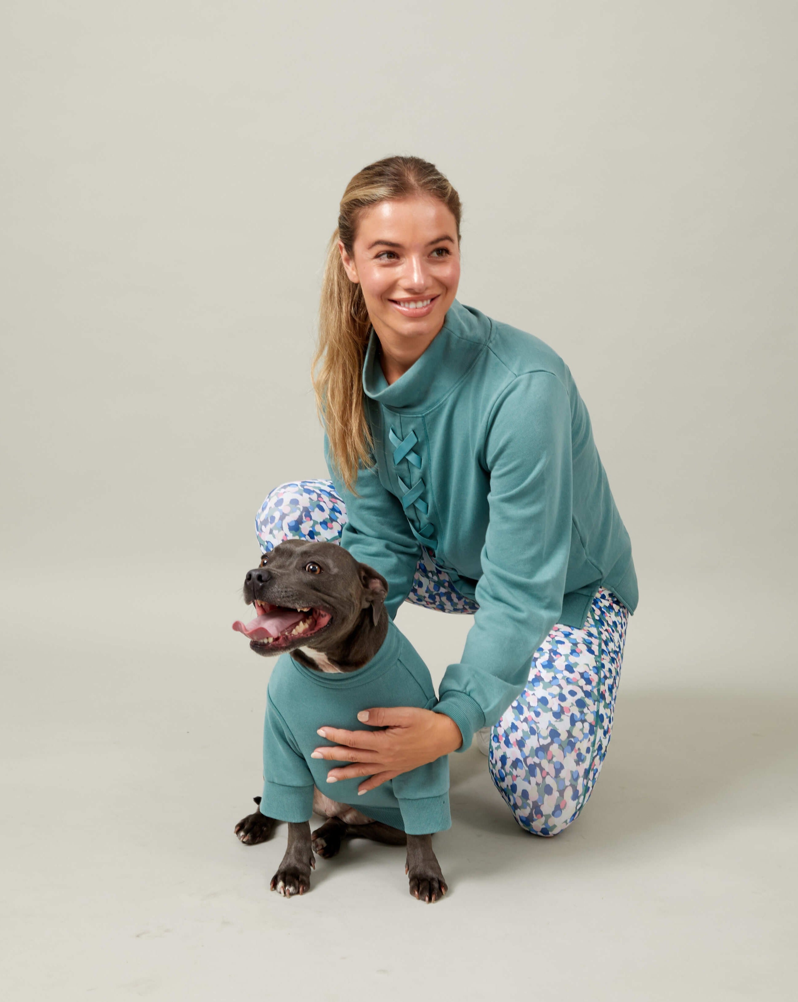 A model and a staffy wearing Darren and Phillip match your dog sweats.