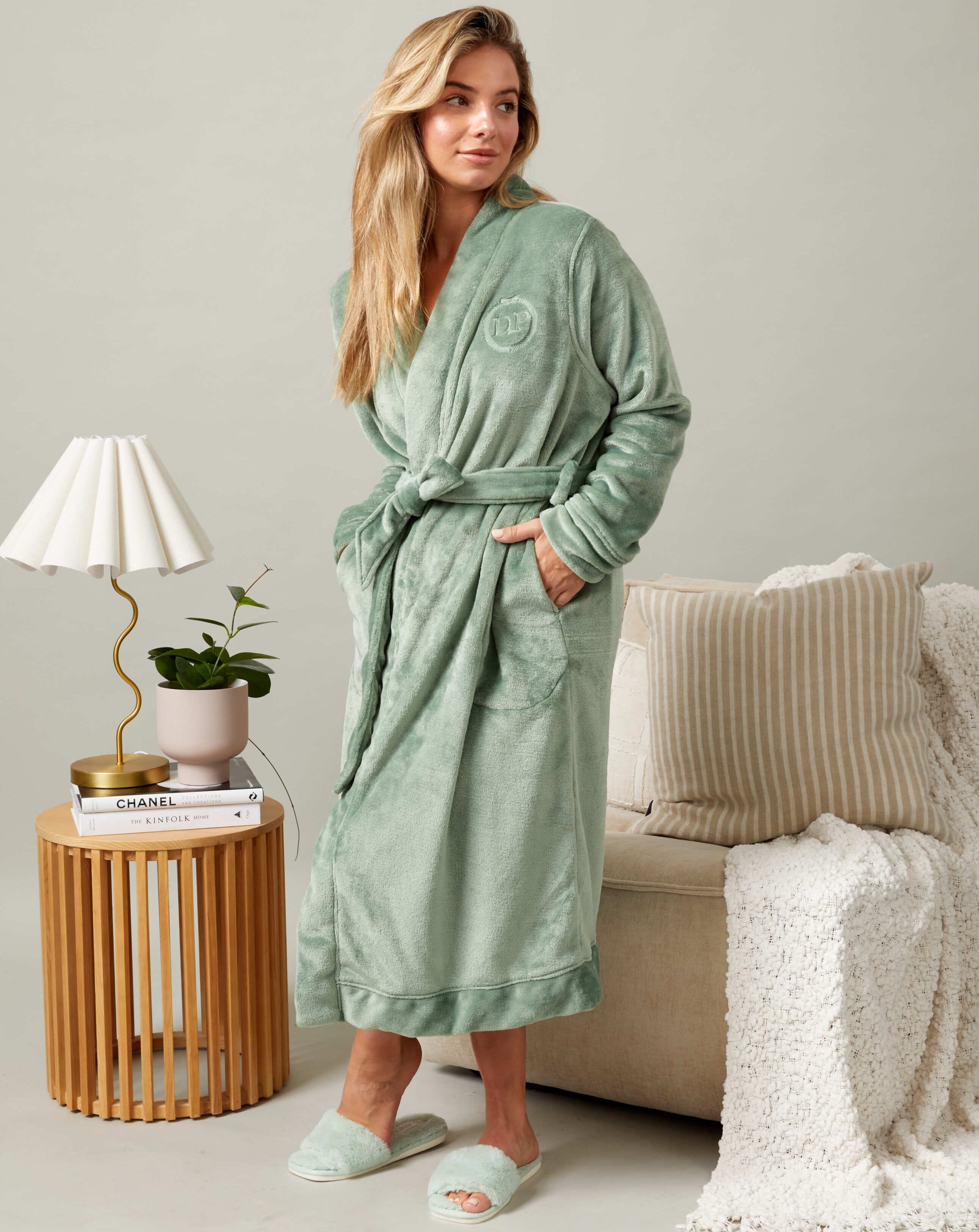 A model wearing a Darren and Phillip match your dog robe in green.